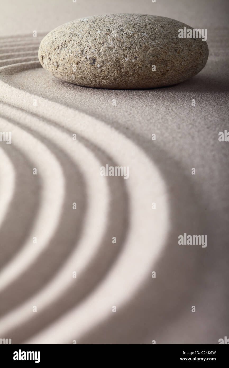 zen garden Japanese garden zen stone with raked sand and round stone tranquility and balance ripples sand pattern Stock Photo