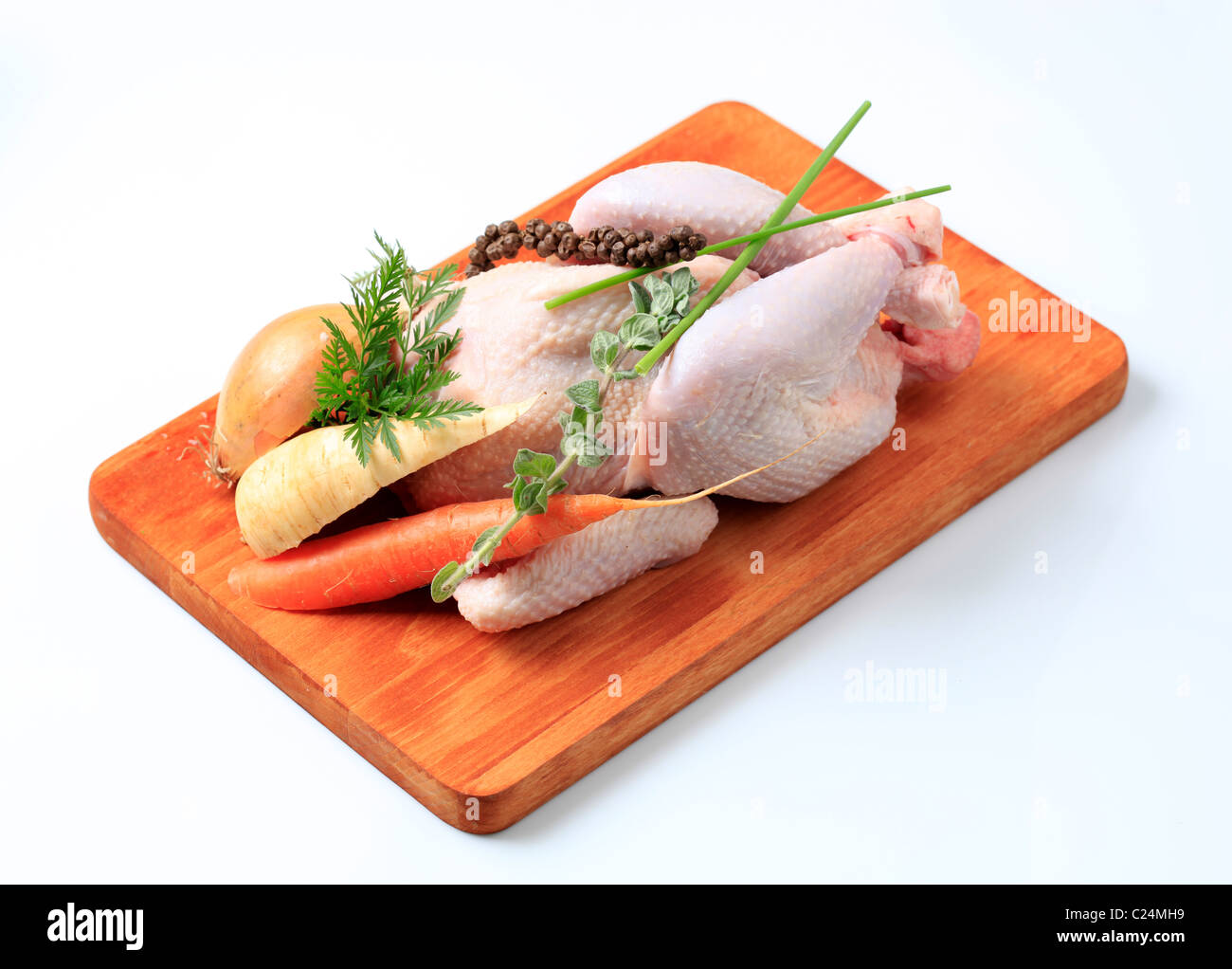 https://c8.alamy.com/comp/C24MH9/raw-chicken-and-vegetables-on-a-cutting-board-C24MH9.jpg