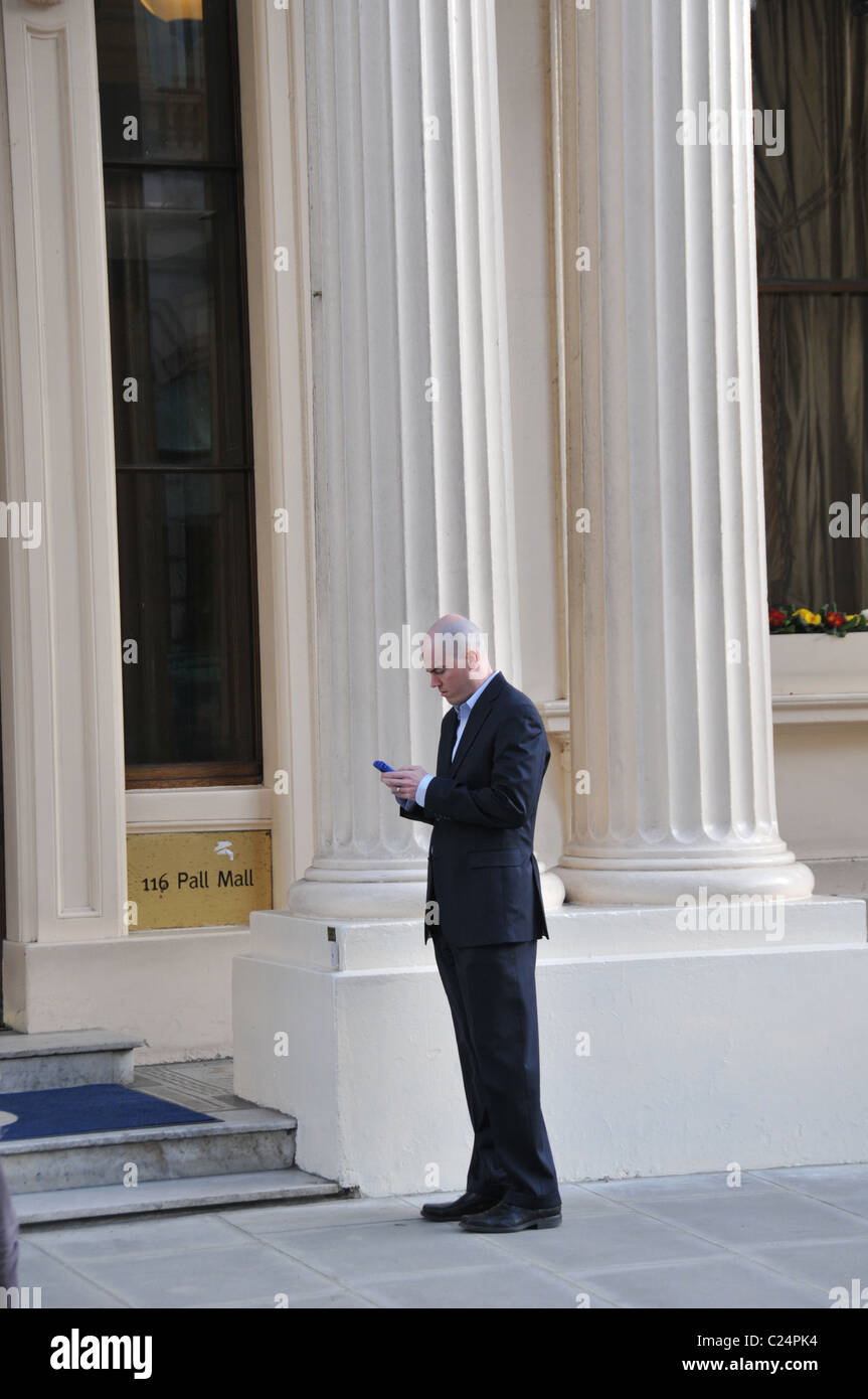 Business man mobile phone IOD The Institute of Directors Head Office Pall Mall London Stock Photo
