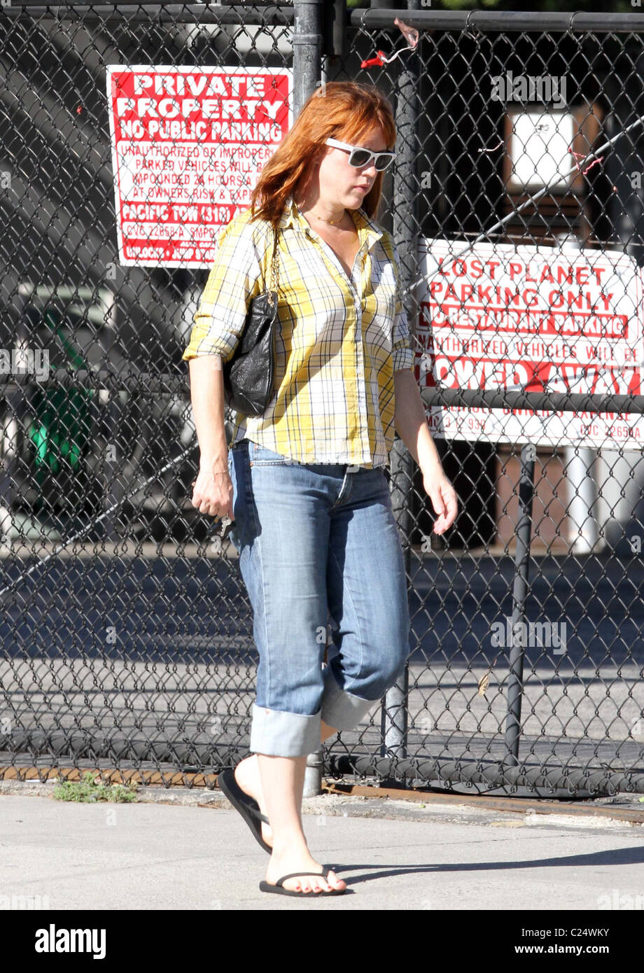 Molly Ringwald walking in Santa Monica wearing sunglasses, checked