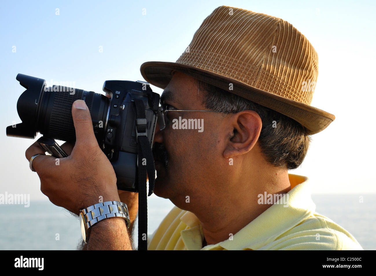 A Indian photographer taking photograph with SLR camera Stock Photo