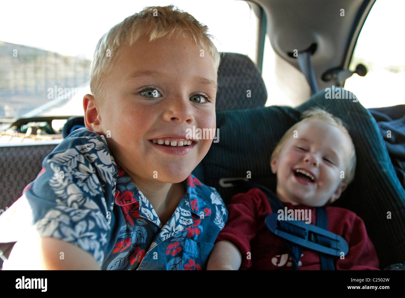 2 Young Brothers Playing in the Car during a family vacation Stock