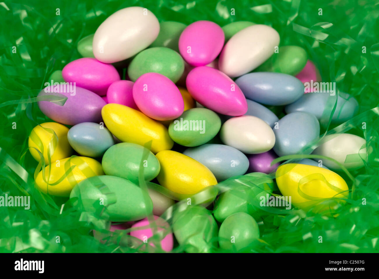 Easter candy. Jordan almonds on Easter grass Stock Photo