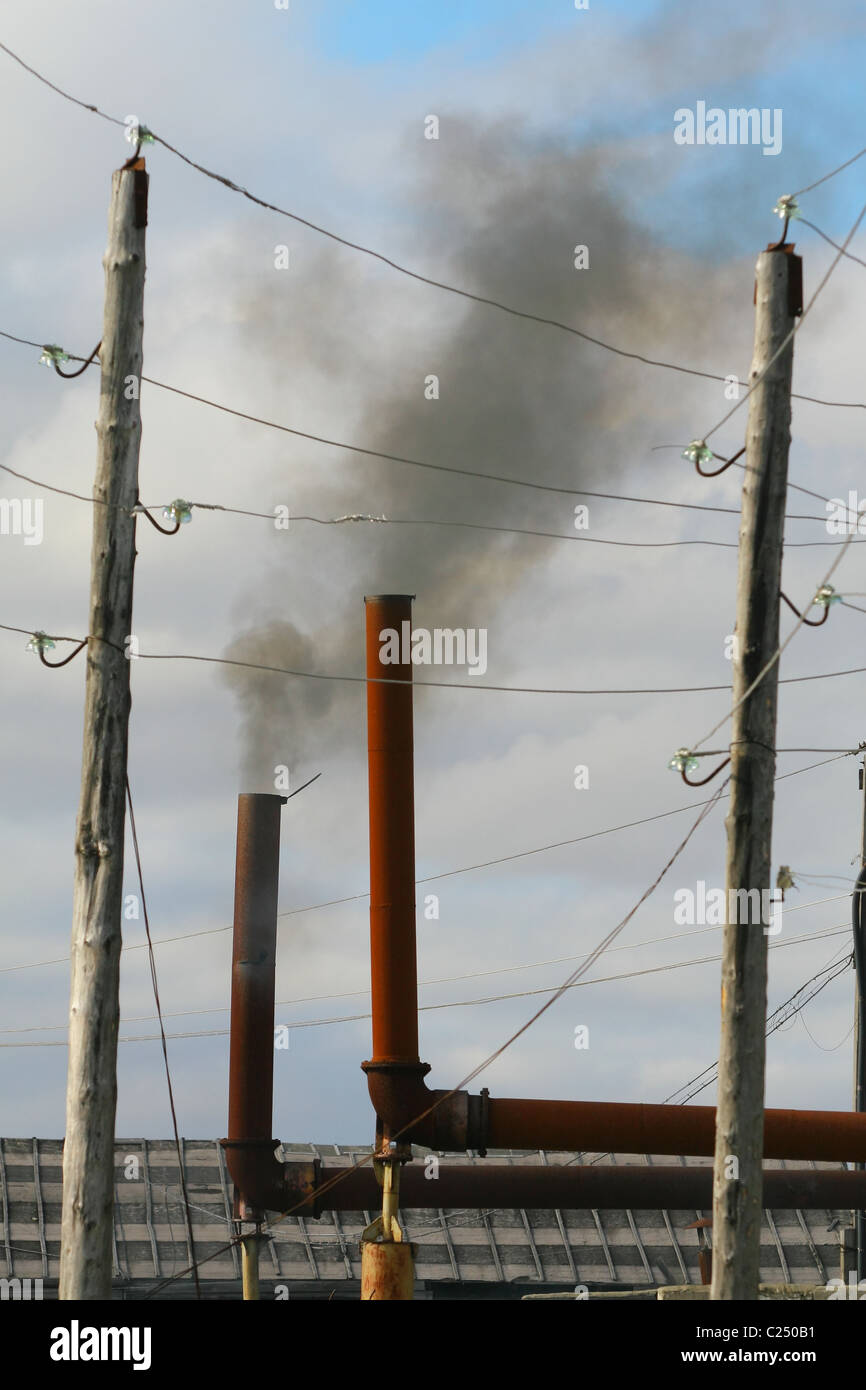 Black smoke from the exhaust pipe of a stationary diesel generator. Settlement Mys-Kamenny, Yamal peninsula, RUSSIA Stock Photo