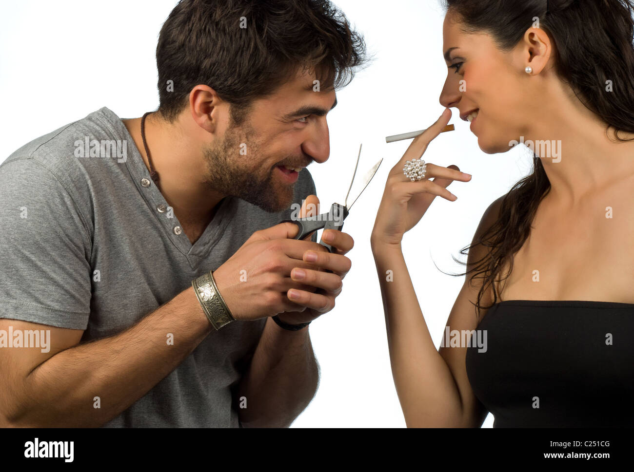 Guy trying to help his girlfriend stop smoking Stock Photo