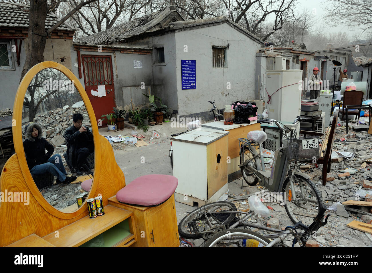 Zhao Couple look at their house being demolished while waiting moving company to move livelihoods in central Beijing.20-Mar-2011 Stock Photo