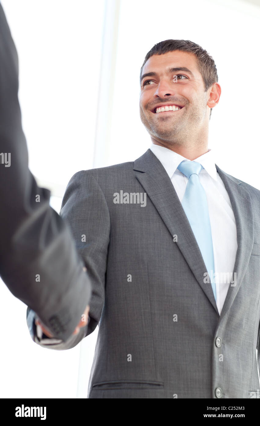 Happy businessmen shaking hands standing in the office Stock Photo