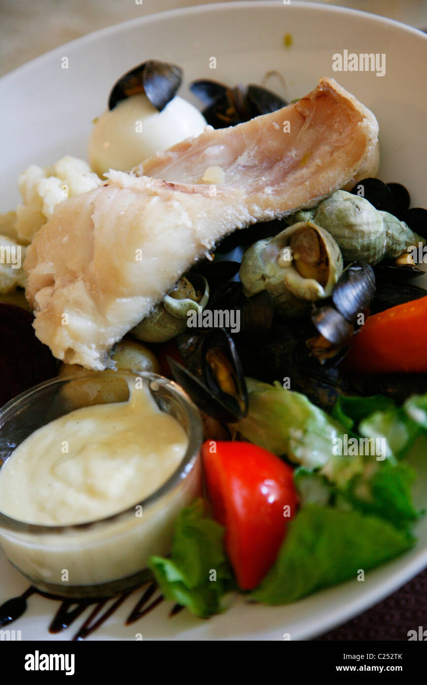 Traditional Provencal Aioli dish served with boiled fish and salad, Provence, France. Stock Photo