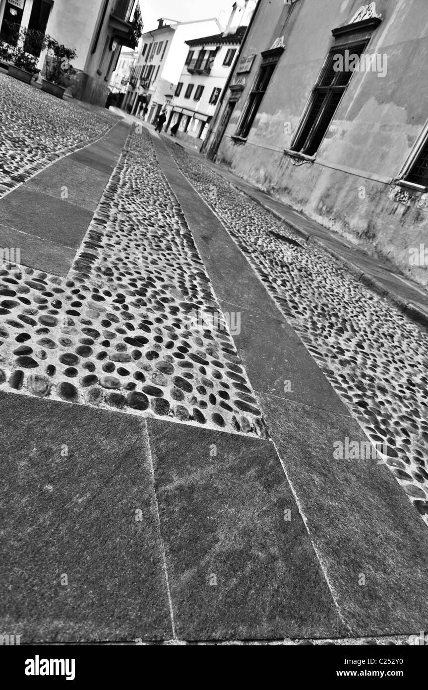 Urban stone pavement of an Italian center town with buildings Stock Photo
