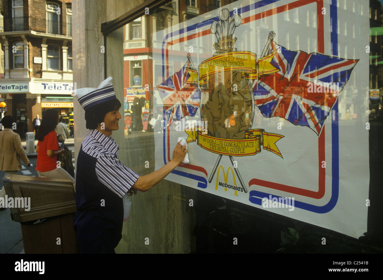 Royal Wedding Prince Charles Lady Di Diana Spencer wedding poster in McDonalds fast food shop resturant window, employee cleaning window. London UK 1980s  July 29th 1981 HOMER SYKES Stock Photo