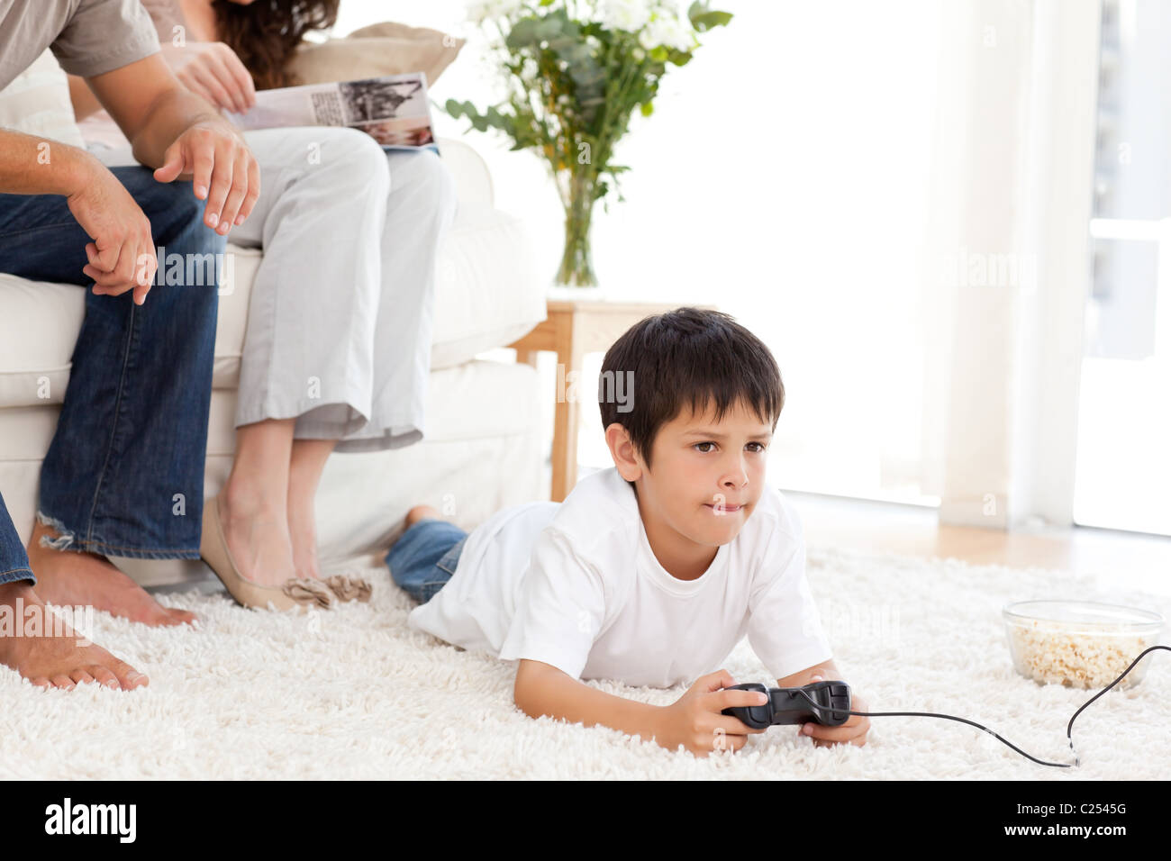 Boy playing video game on floor hi-res stock photography and images - Alamy
