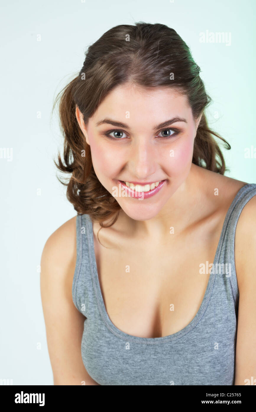 Portrait of smiling pretty teenager girl against white background Stock Photo