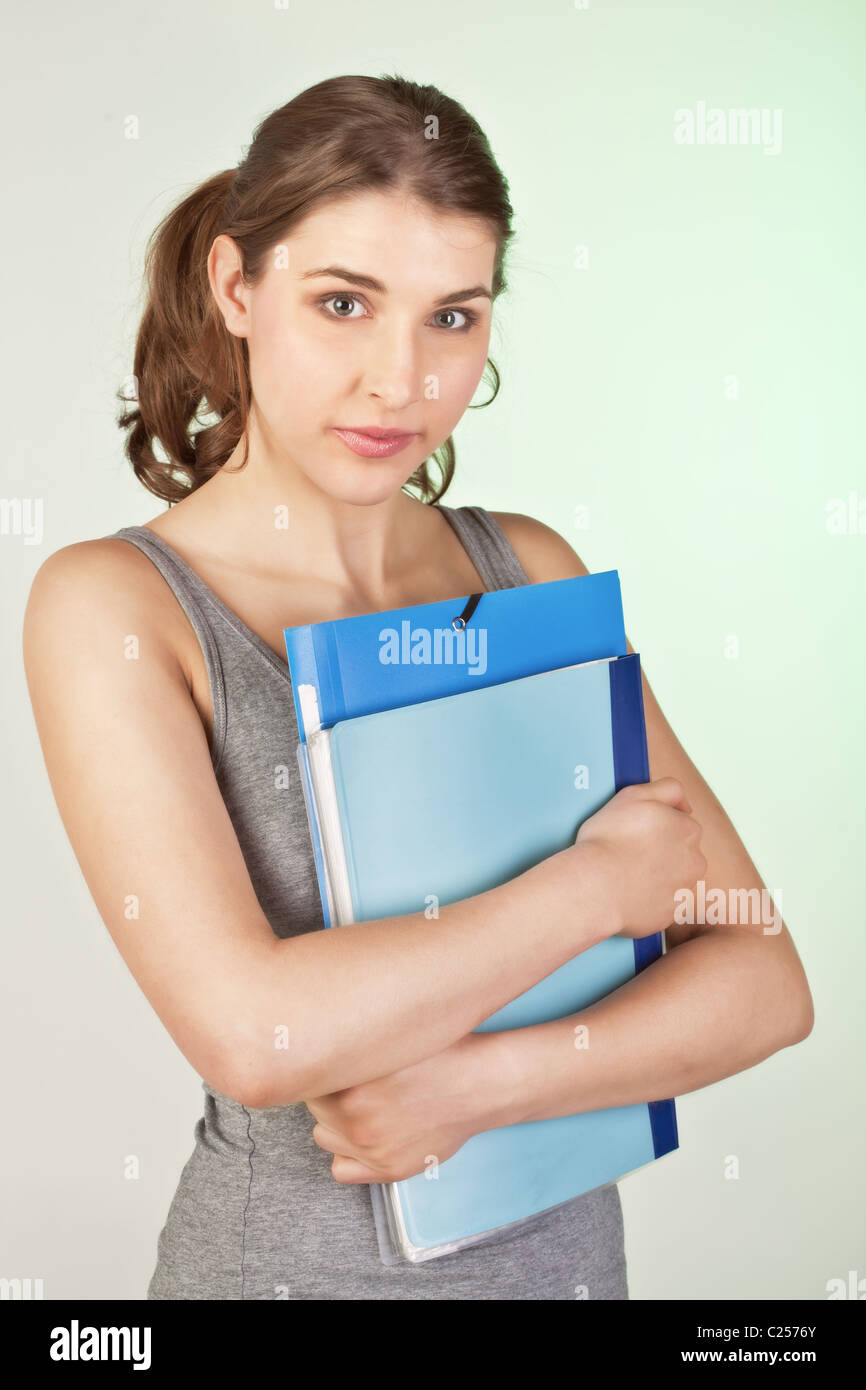 Pretty teenager girl holding blue plastic folders Stock Photo