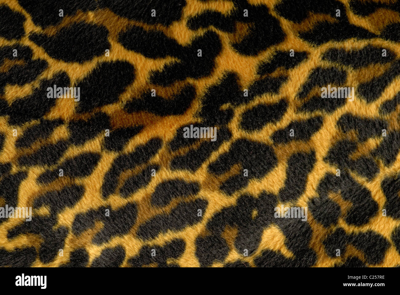 Yellow, brown and black cheetah print fabric. Stock Photo
