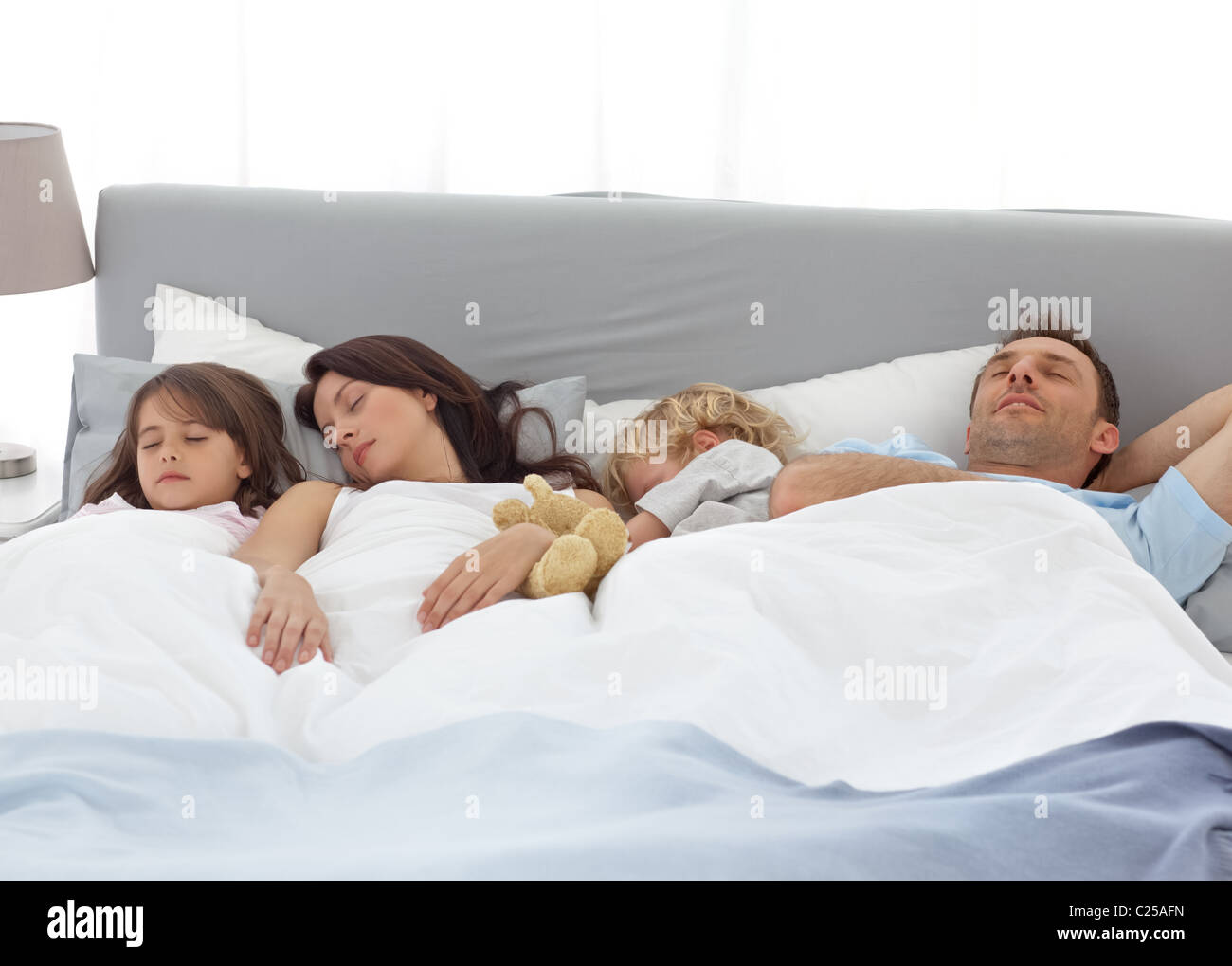 Tranquil children sleeping with their parents Stock Photo Alamy