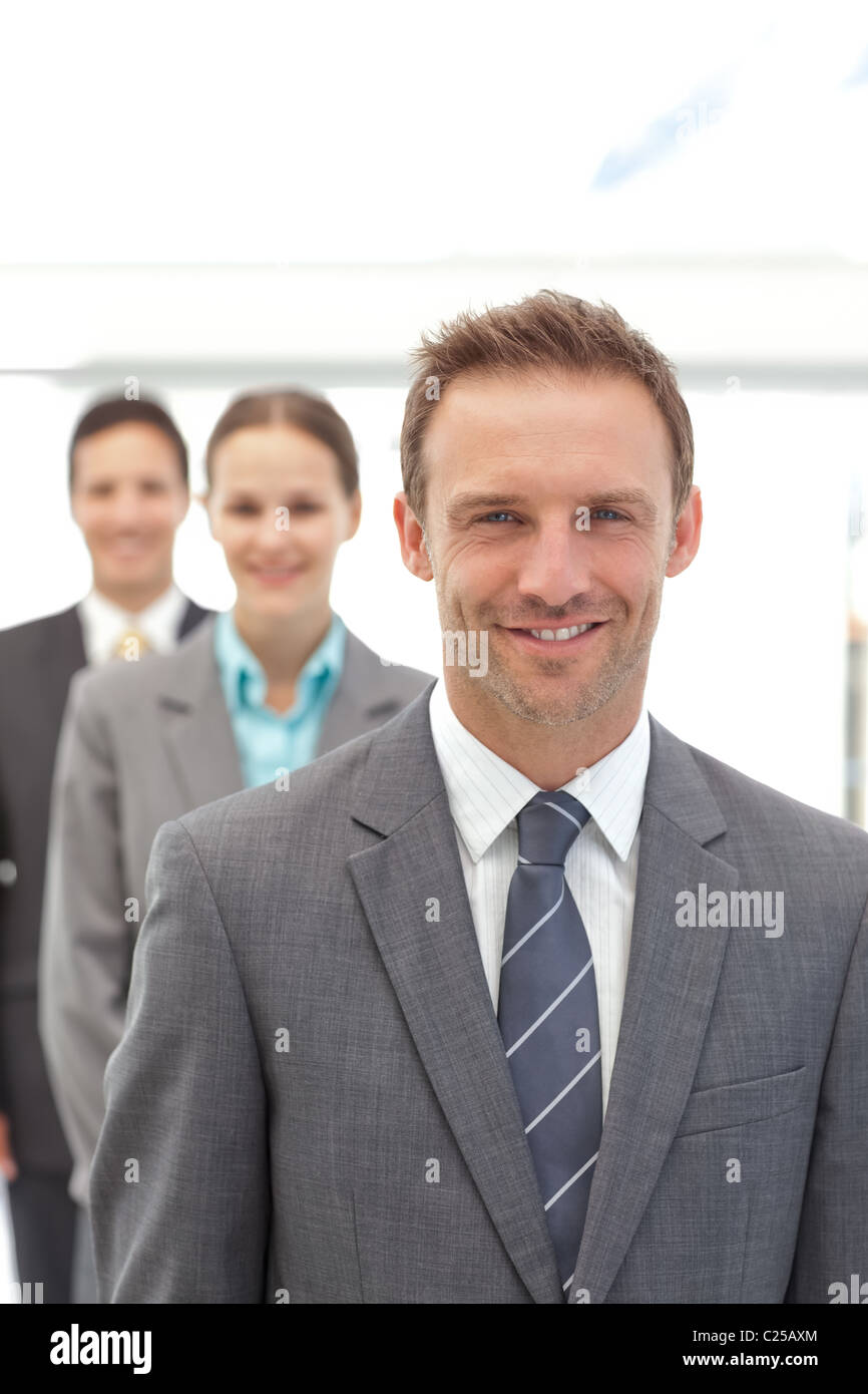 Three happy business people posing in a row Stock Photo - Alamy