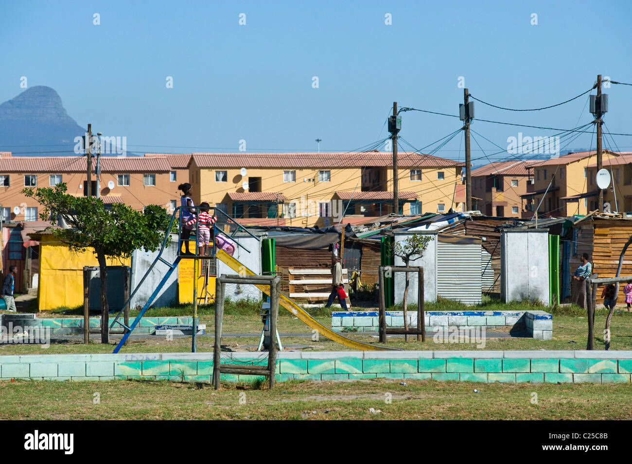 A playground with shacks and new housing along Vanguard Drive, Epping, Cape Town, South Africa Stock Photo
