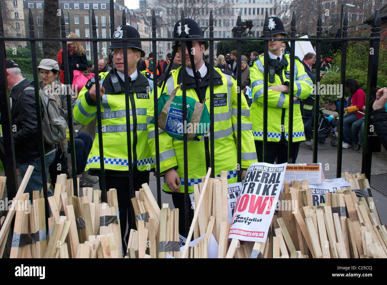 Policemen look on as student tuition fee protesters march down Victoria Embankment towards Westminster and Trafalgar Square during 2010. Stock Photo