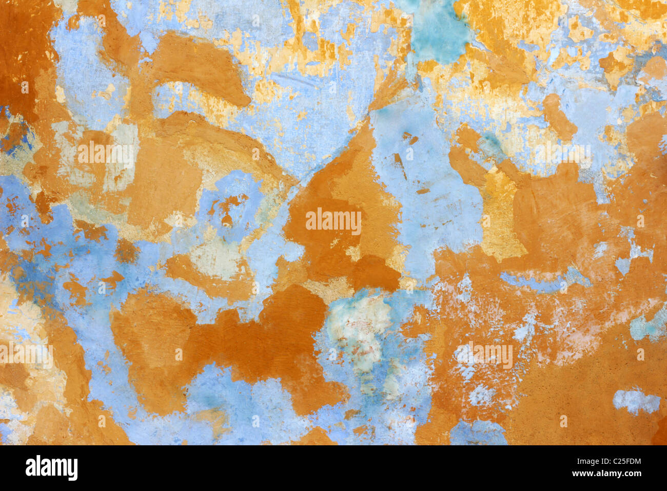 Paint coming off from old wall while past color is showing Stock Photo