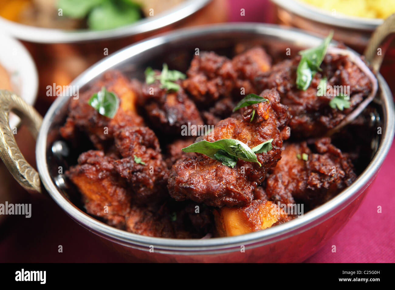 Authentic Kerala chicken fry garnished with curry leaves, a popular