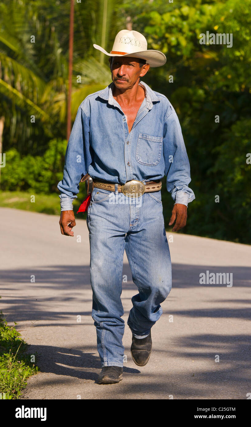 https://c8.alamy.com/comp/C25GTM/remate-guatemala-man-wearing-blue-jeans-and-cowboy-hat-walks-on-road-C25GTM.jpg