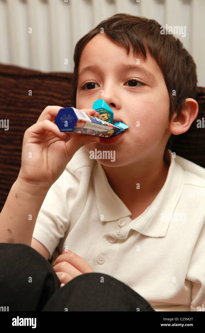 5 year old boy eating Smarties Stock Photo