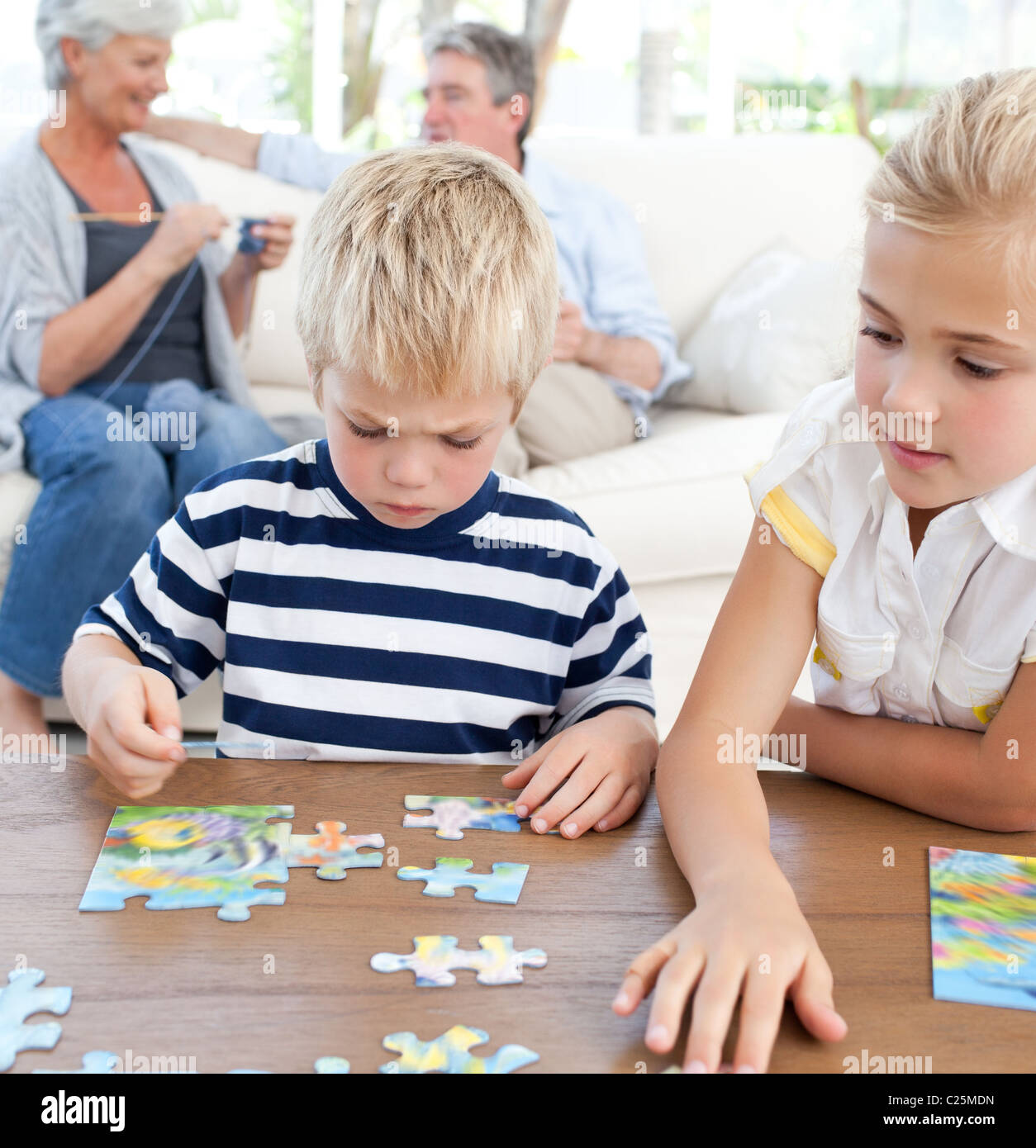 Children playing together jigsaw puzzle hires stock photography and