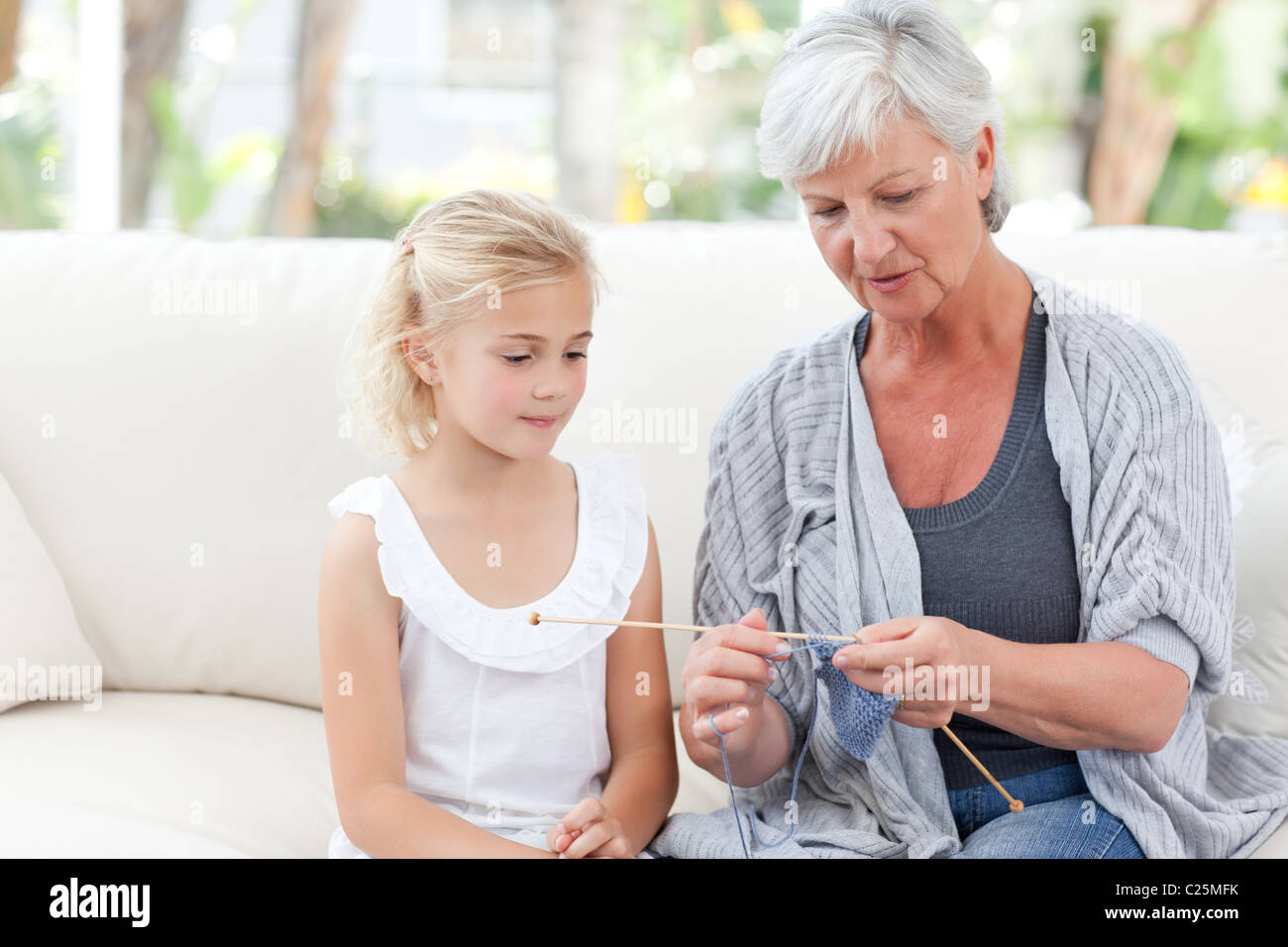 Senior knitting with her granddaughter Stock Photo Alamy