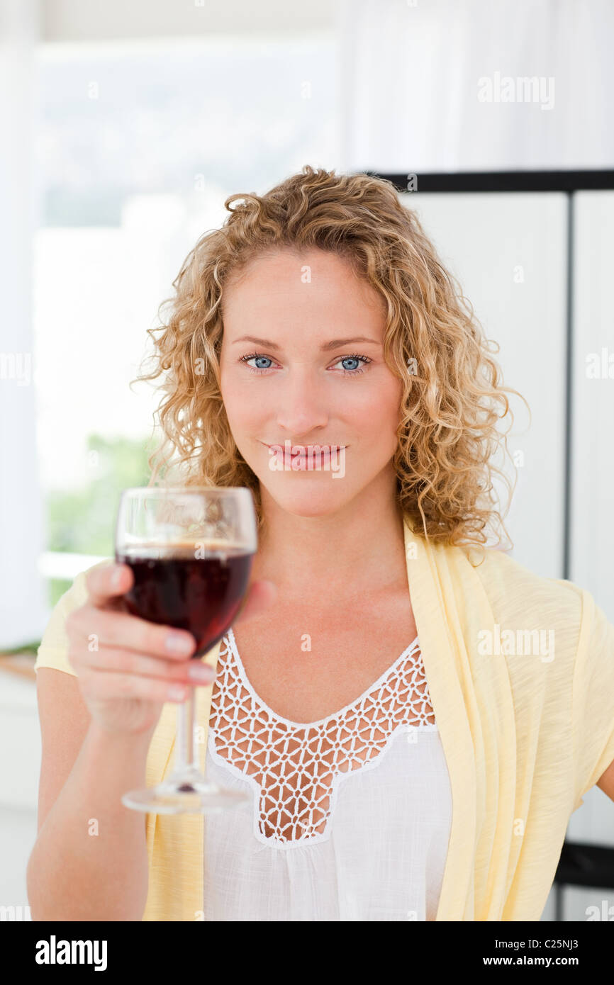 Woman looking at the camera with her drink of wine Stock Photo - Alamy