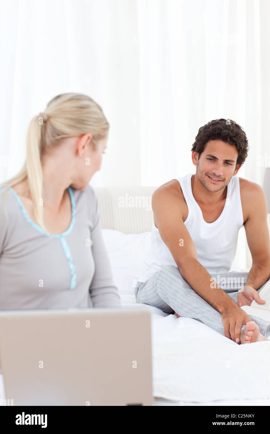 Woman talking with her boyfriend on the bed Stock Photo - Alamy