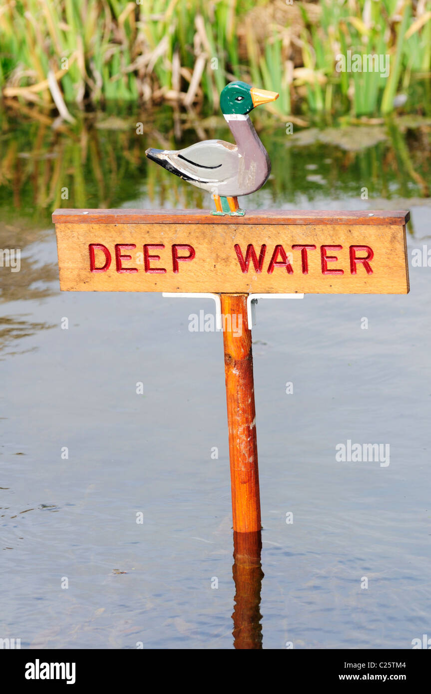 Deep Water Warning Sign in a Pond, Barrington, Cambridgeshire, England, UK Stock Photo