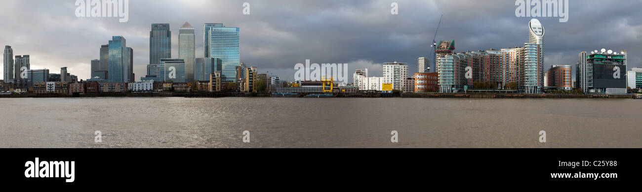 Panorama of Canary Wharf and docklands from the river Thames in London. Scene taken from the 02 Arena area. Stock Photo