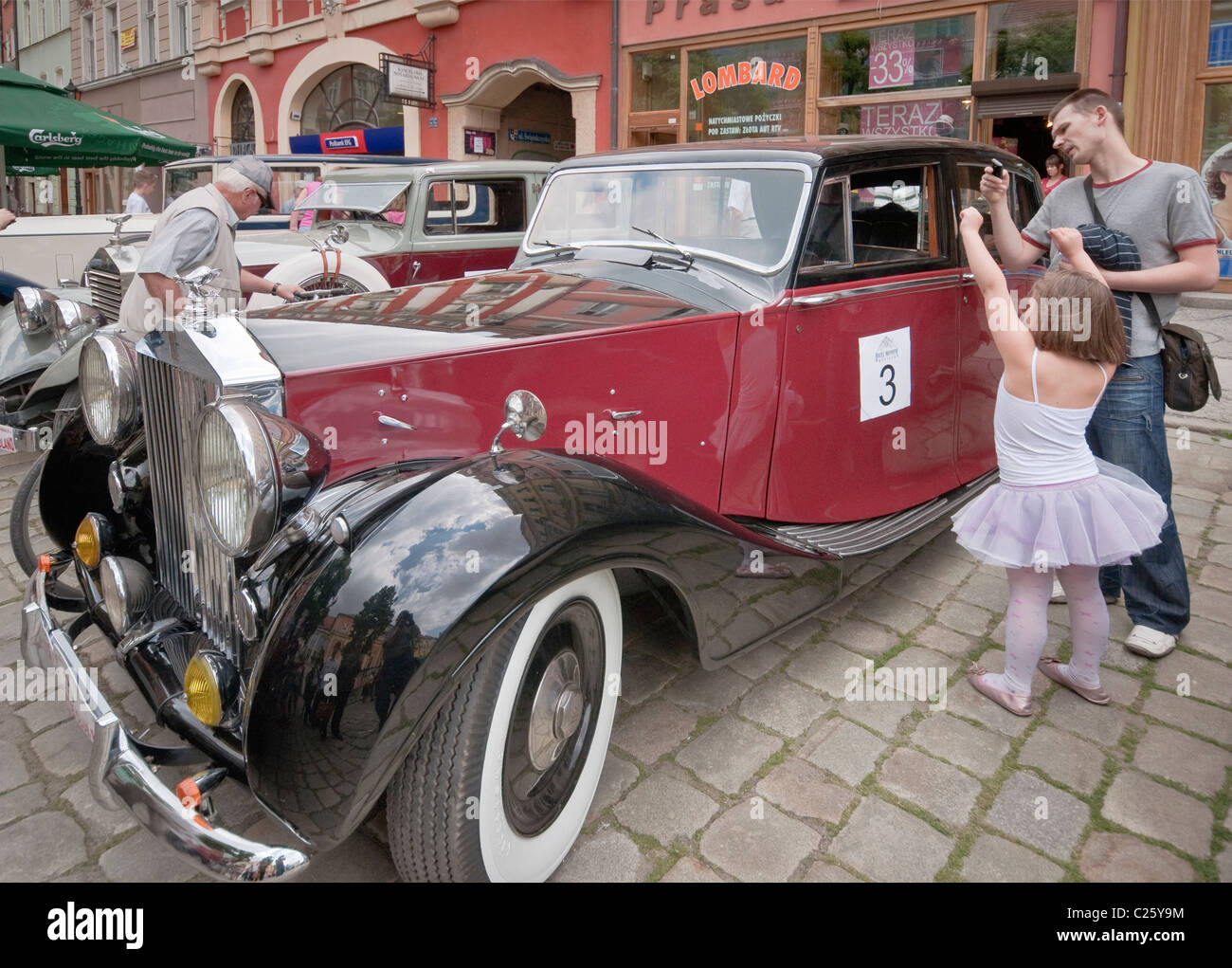 Man and daughter looking at 1948 Rolls-Royce Silver Wraith at Rolls-Royce & Bentley Club meeting in Świdnica, Silesia, Poland Stock Photo