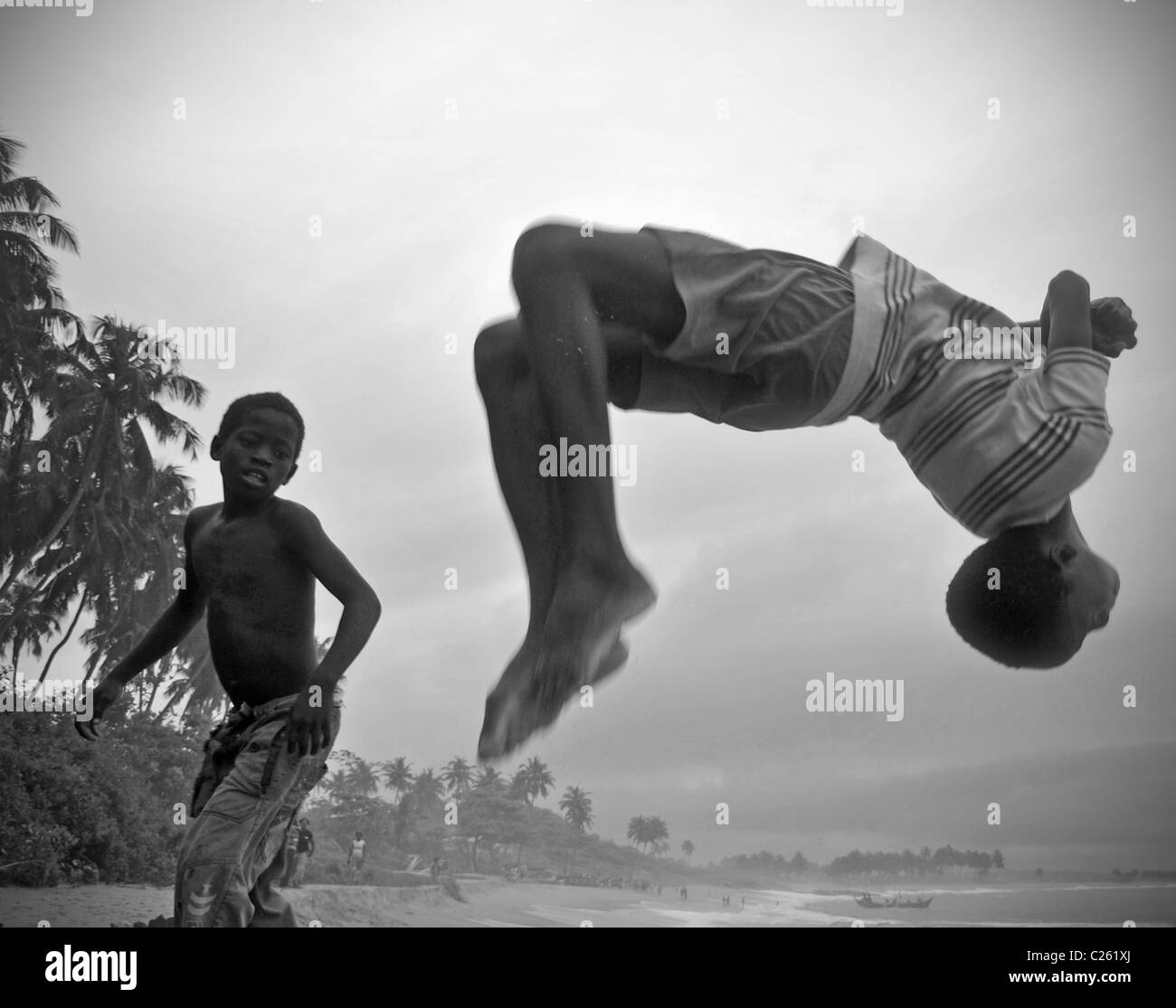 Children doing somersaults on Tabou beach, Ivory Coast Stock Photo