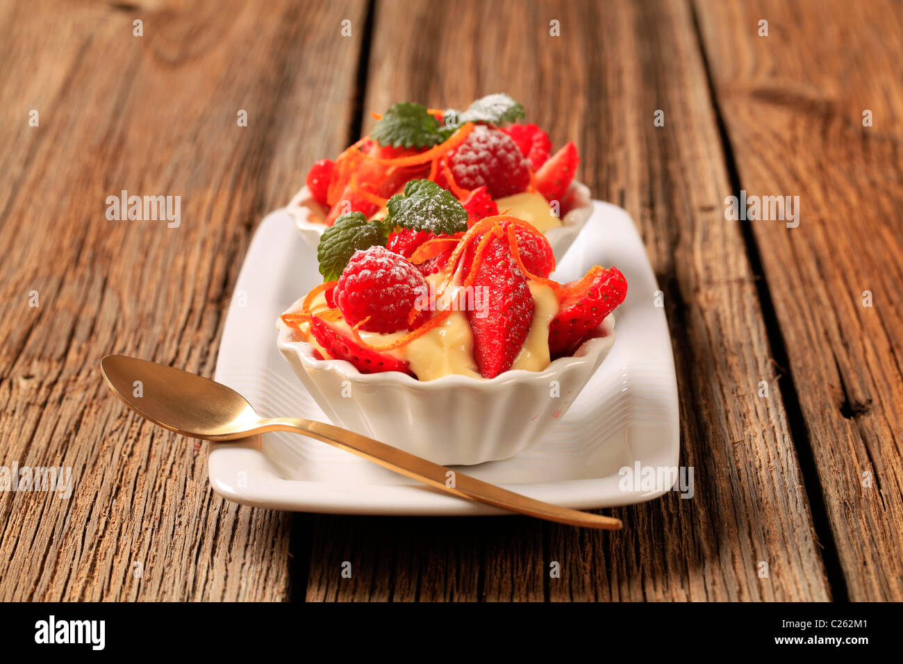 Creamy pudding and fresh fruit in small dessert dishes Stock Photo