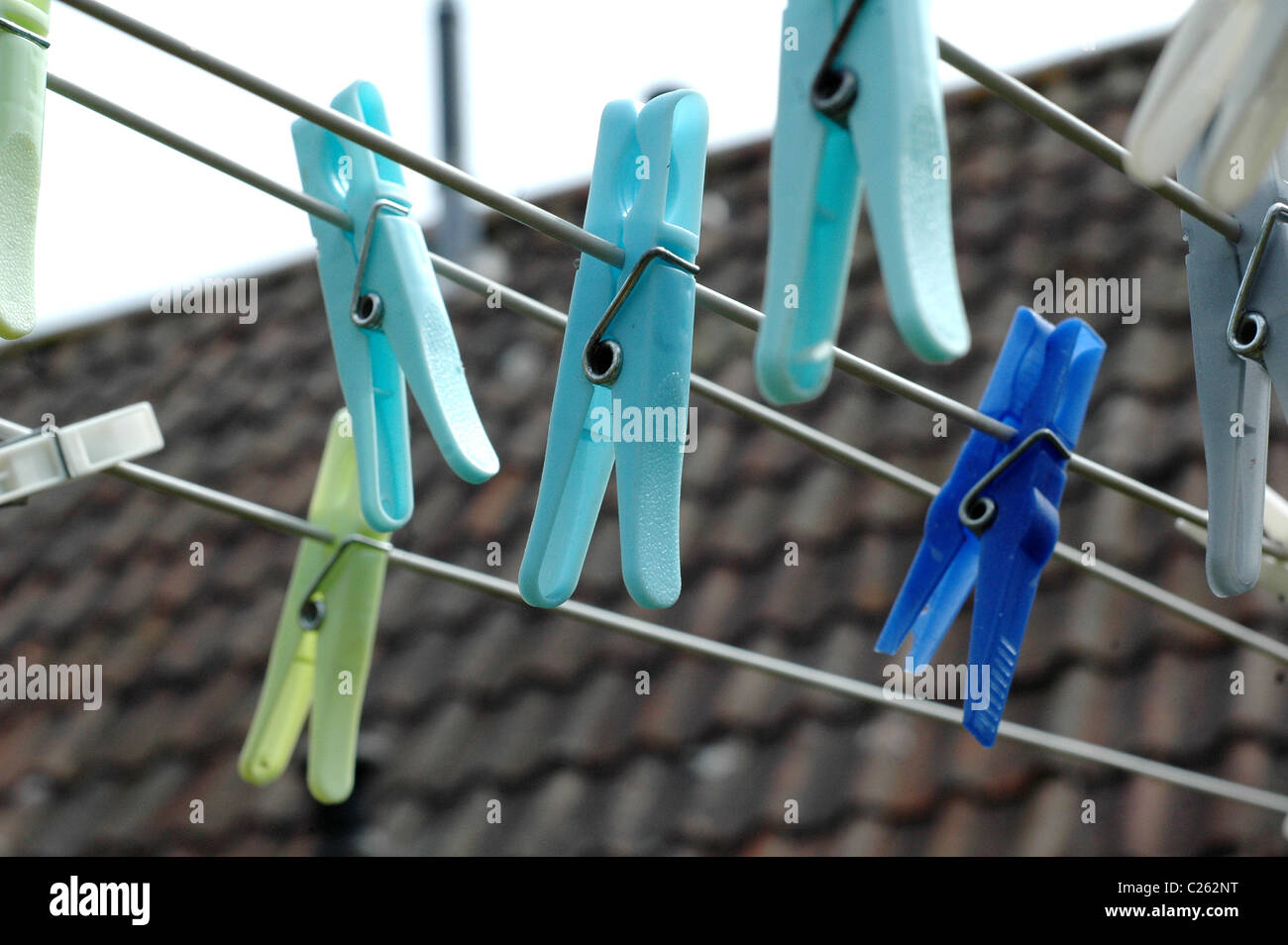 Colourful Clothes pegs on a washing line Stock Photo