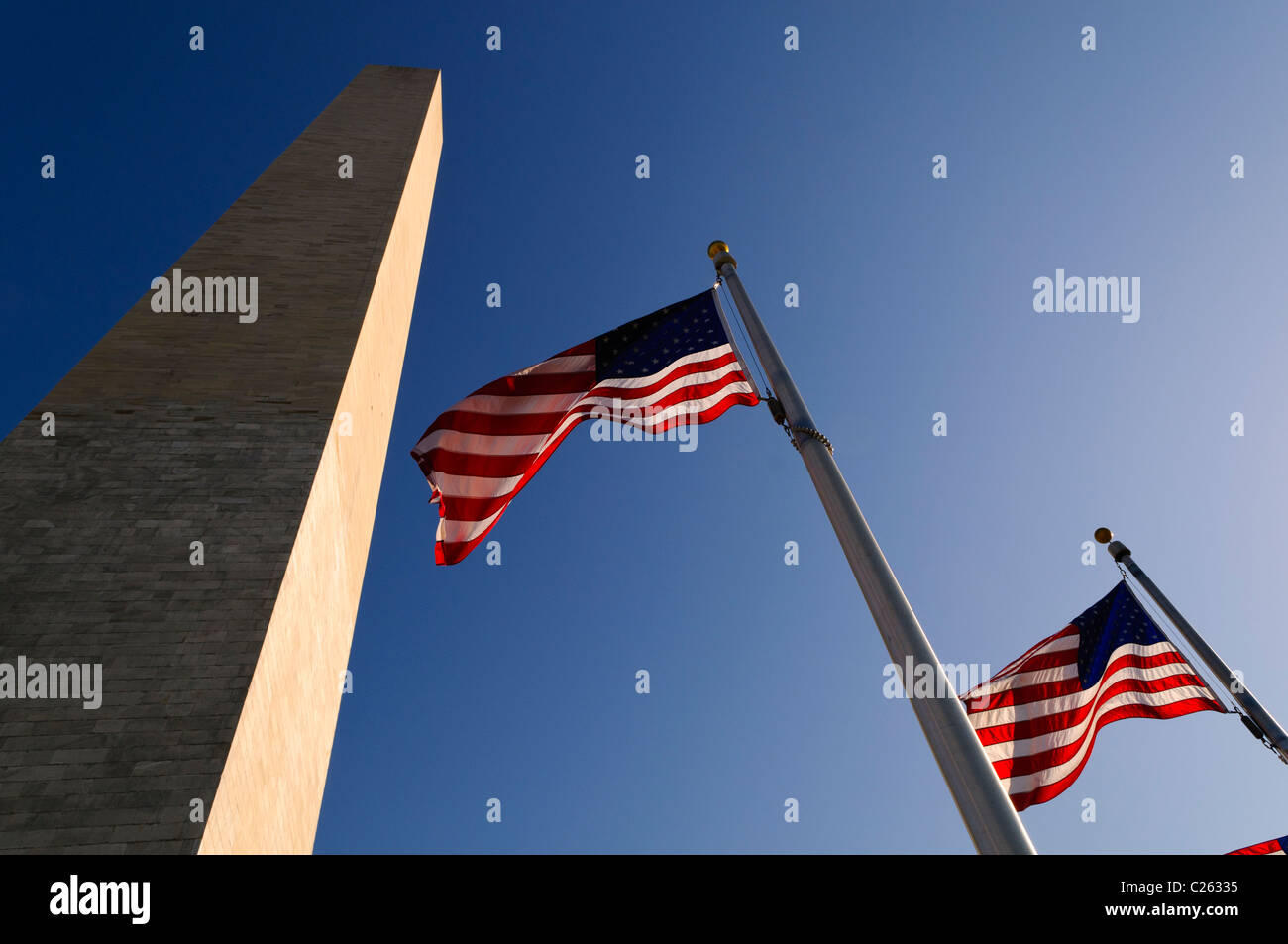 WASHINGTON DC, USA - The Washington Monument and American flags against a clear blue sky in early spring in Washington Dc Stock Photo