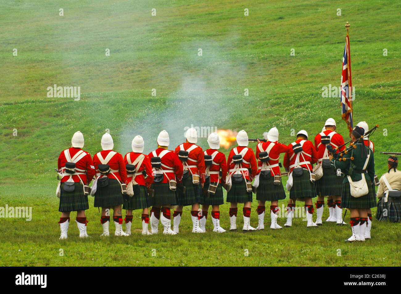 Men wearing the uniforms of The Gordon Highlanders fire replica weapons during a historical reenactment in Halifax, Nova Scotia. Stock Photo