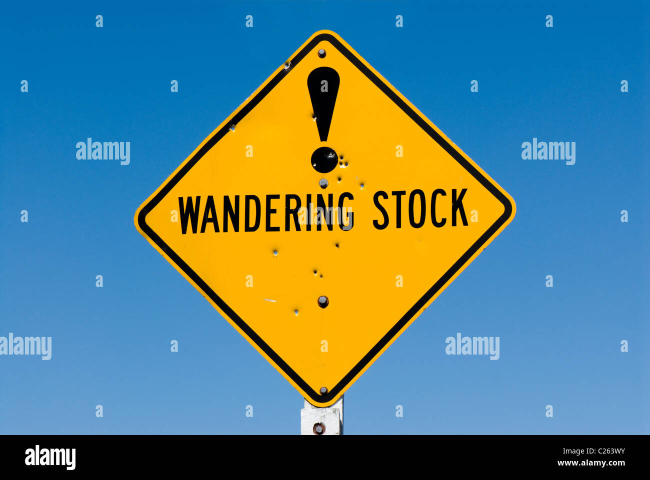 Wandering stock warning sign with exclamation mark and bullet holes Stock Photo
