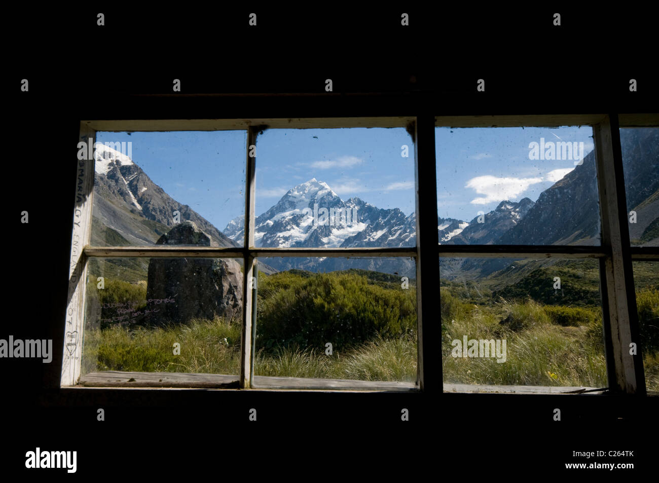 Mt Cook seen though the windows of the Stocking Stream Shelter hut in the Hooker Valley, South Island of New Zealand Stock Photo