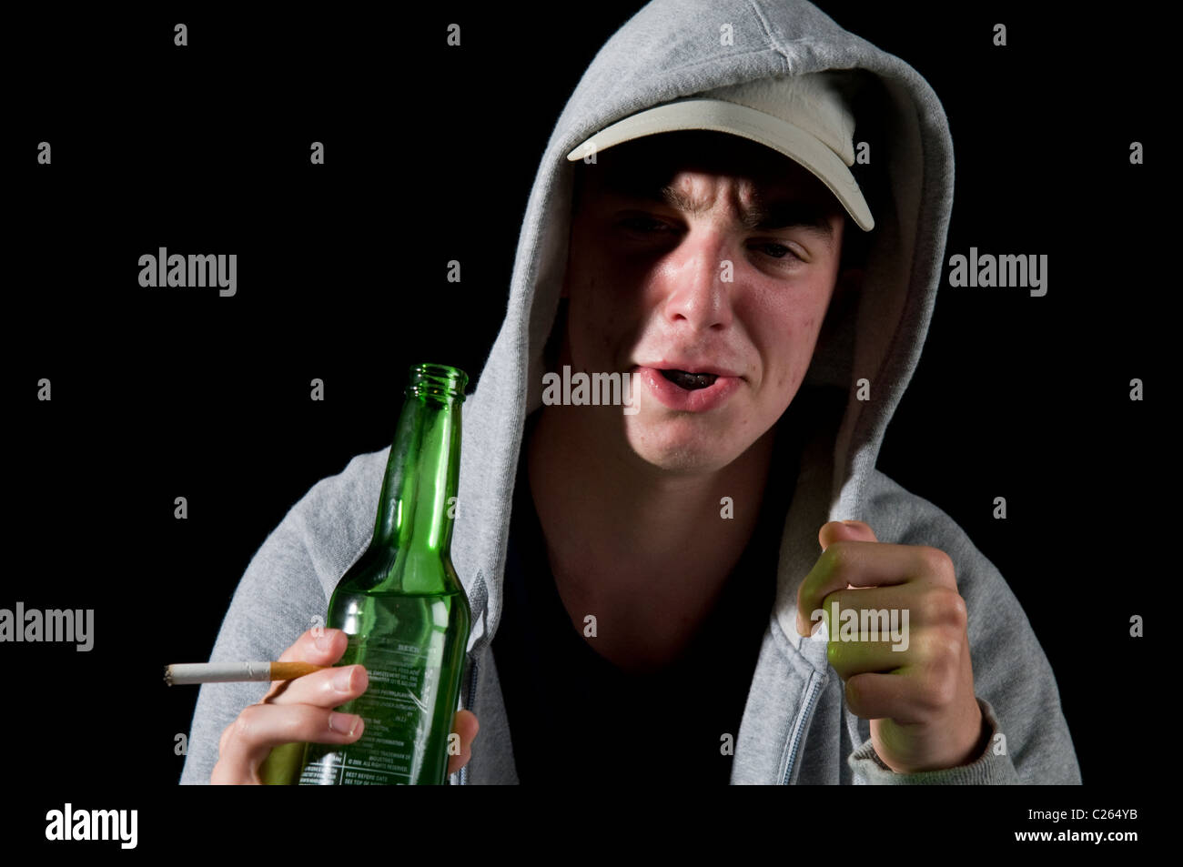 Teen boy smoking and drinking Stock Photo
