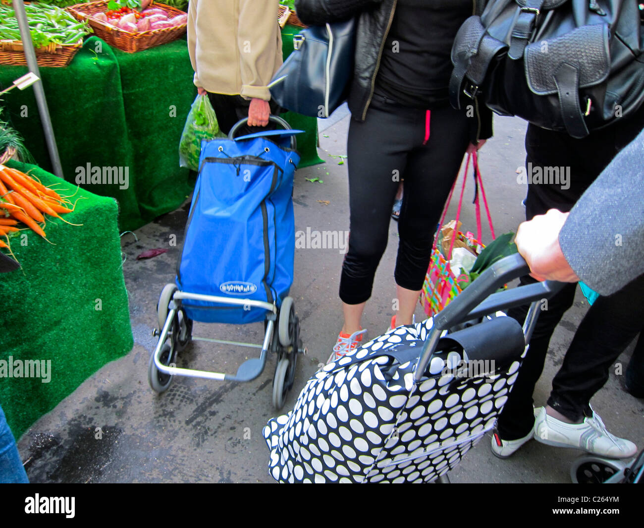 Fresh vegetables detail hands carts consumers consuming outside street