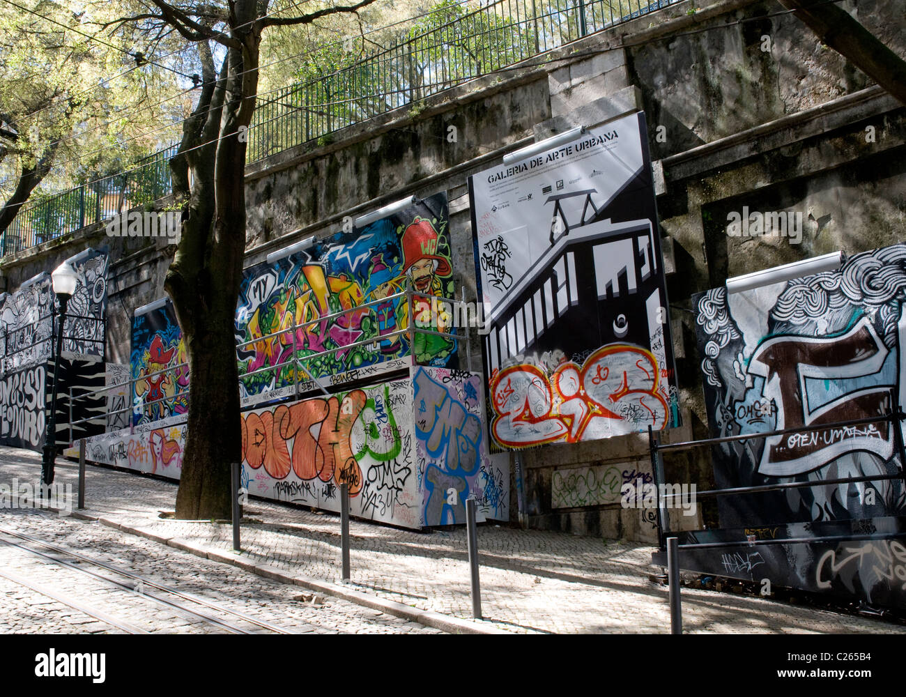 Graffiti decorates the walls of Calçada da Glória, a steep narrow road in central Lisbon Stock Photo