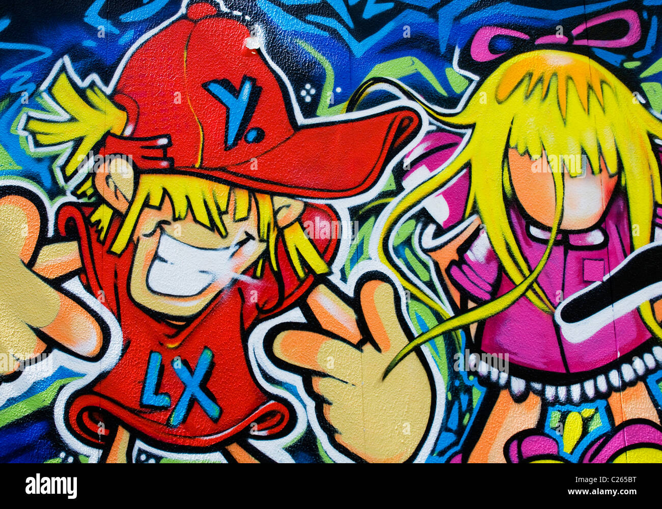 Detail of professional graffiti in Lisbon depicting cartoon male and female characters Stock Photo