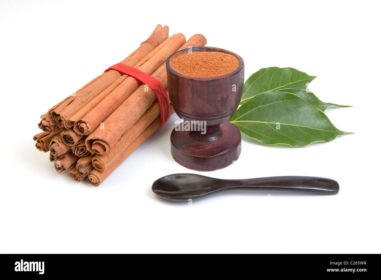 Bundle of cinnamon with powder and leaves Stock Photo