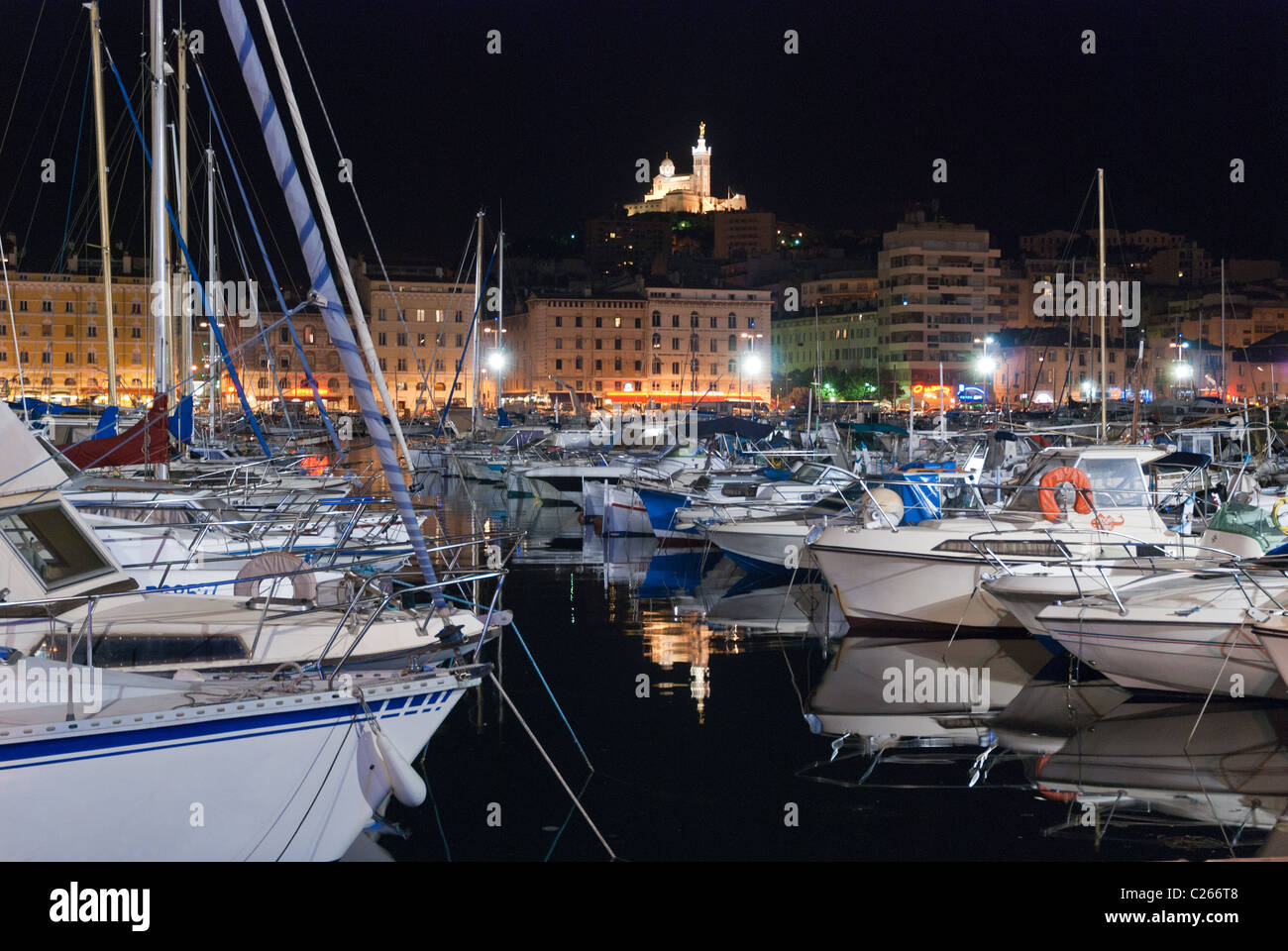 The Marseilles Vieux-Port at night with the Notre-Dame-de-la-Garde in ...