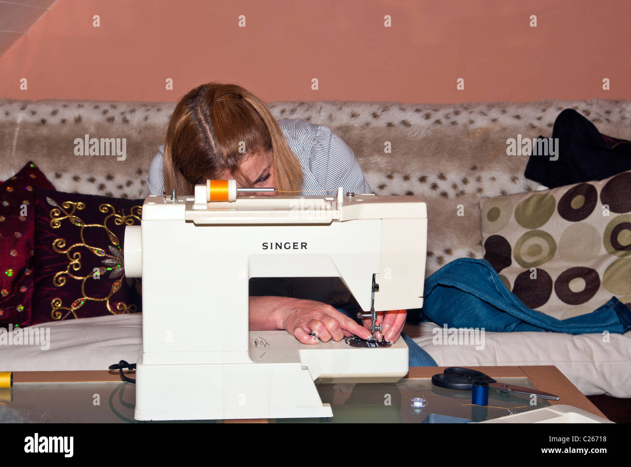 Woman Using Sewing Machine Stock Photo Alamy