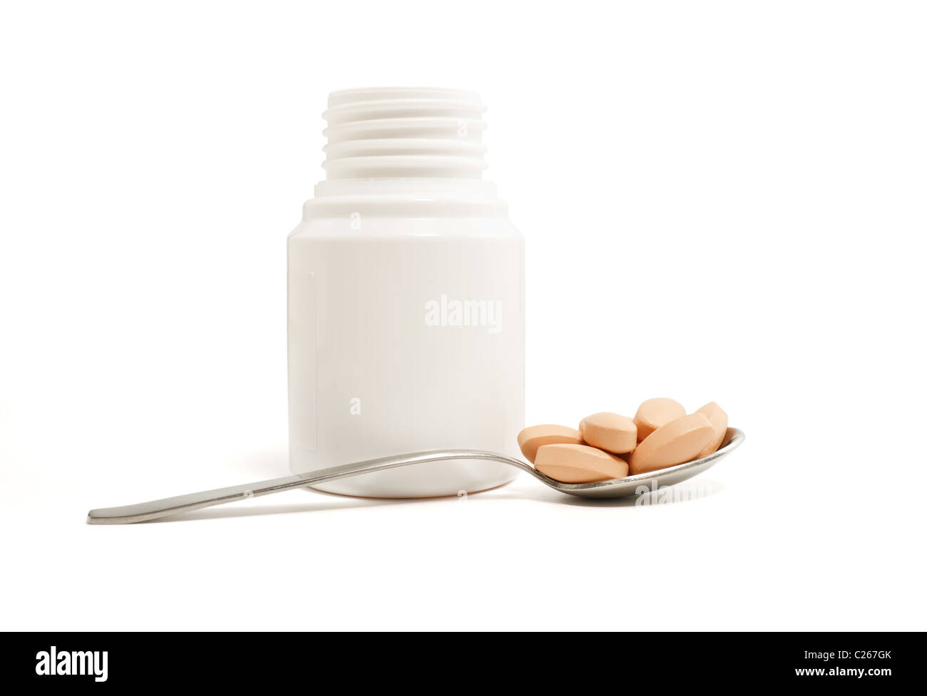 medicine bottle, spoon and pills on white background Stock Photo Alamy