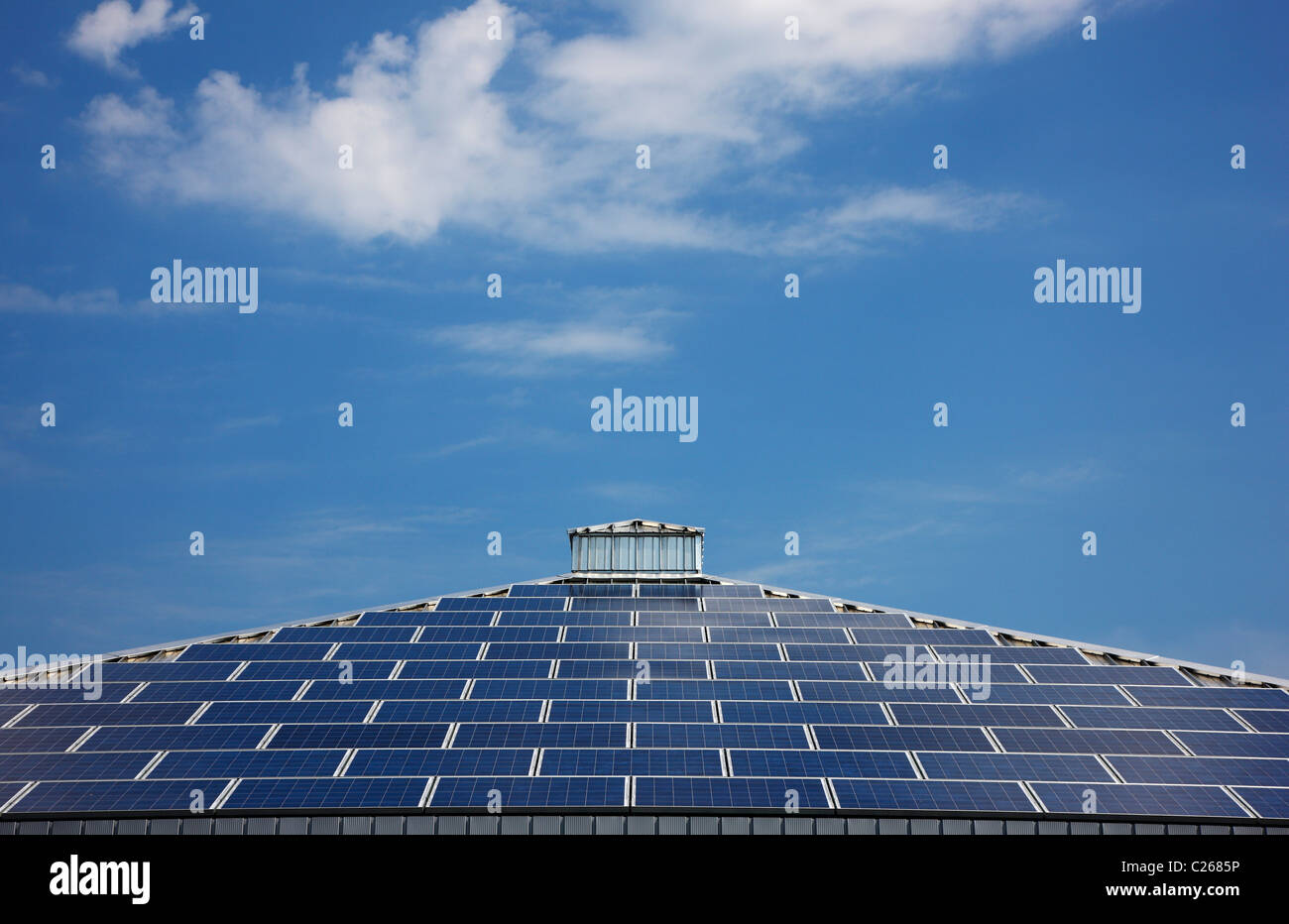 Roof of a building with solar energy panels. Blue sky, pyramid design. Germany. Stock Photo