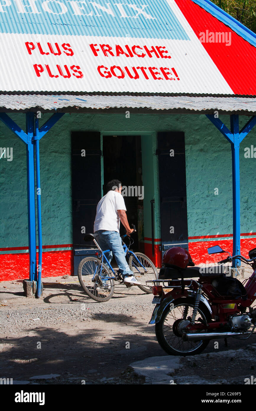 Cyclist arrives at supermarket, Cap Malheureux, Mauritius Stock Photo